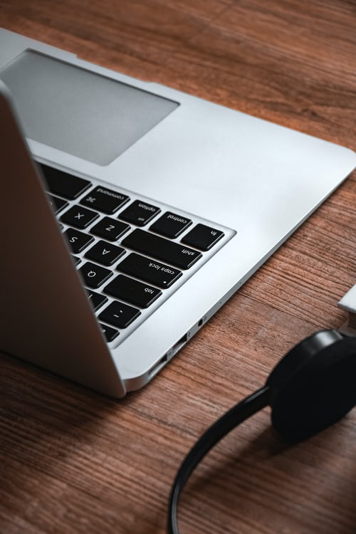 Photo of the back of an open laptop on a desk.